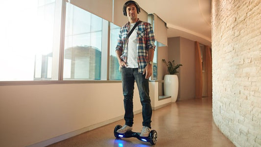 A man riding Rideo hoverboard on floor