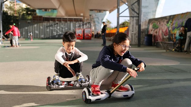 Two kids playing with rideo hoverboard