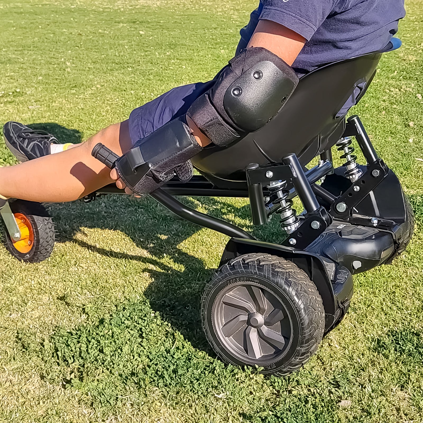 Experience the thrill with the RIDEO Hoverboard Go-Kart A5, featuring robust suspension and adjustable frame, showcased here in a lush park setting, perfect for outdoor fun.