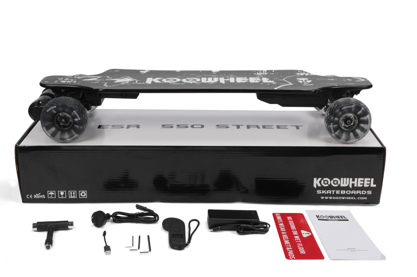  An image displaying the unboxing of a Koowheel ESR 550 Street electric skateboard, featuring the board itself along with various accessories like a remote control, charging cables, and tools, neatly arranged next to the product packaging.