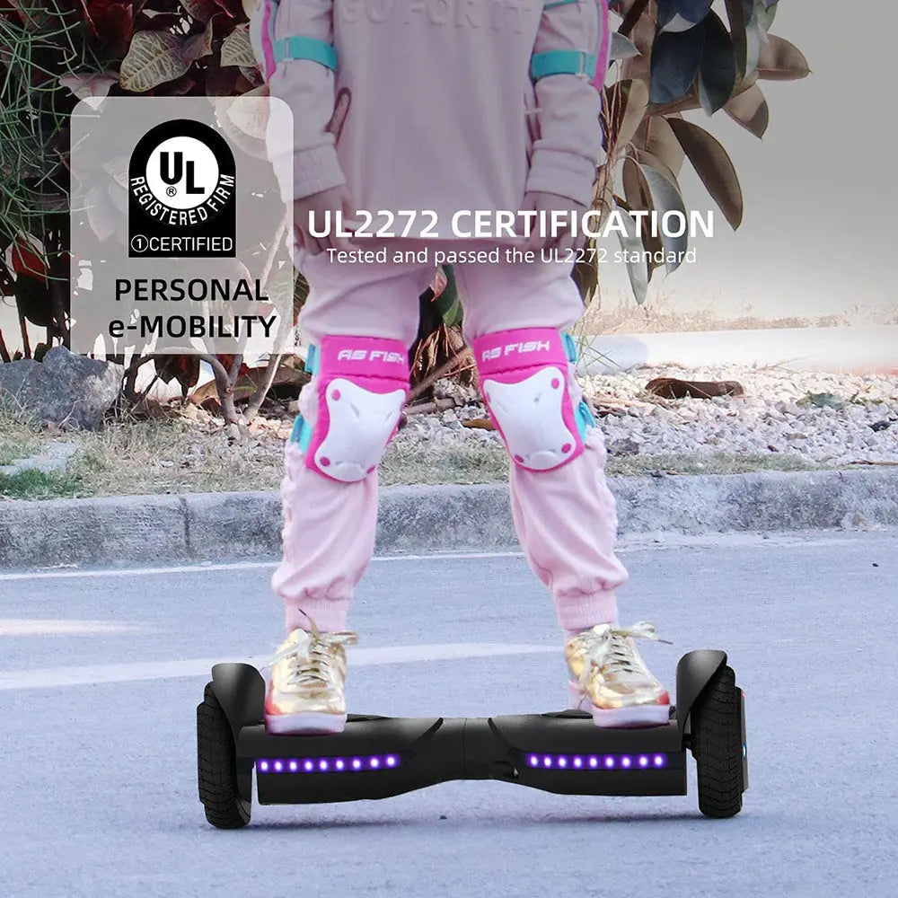 Young girl in protective gear riding a blue hoverboard outdoors, emphasizing the safety and real-world functionality of the hoverboard.