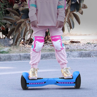 Young girl in protective gear riding a blue hoverboard outdoors, emphasizing the safety and real-world functionality of the hoverboard.