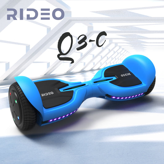 Dynamic portrayal of a blue RIDEO Q3-C hoverboard in a modern, architectural environment, highlighting its sleek design and vibrant undercarriage lighting.